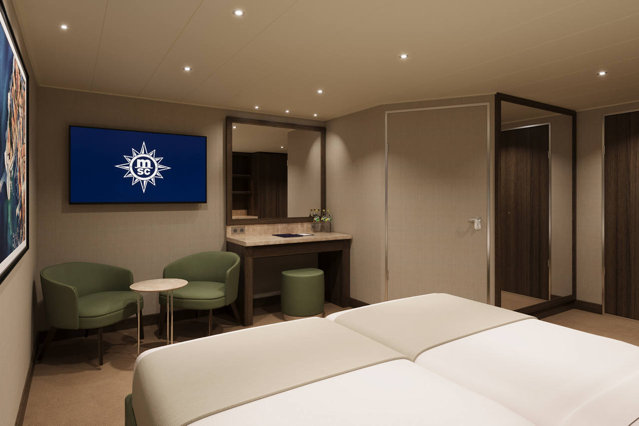 Modern cabin with two beds and comfortable seating areas | MSC Cruises