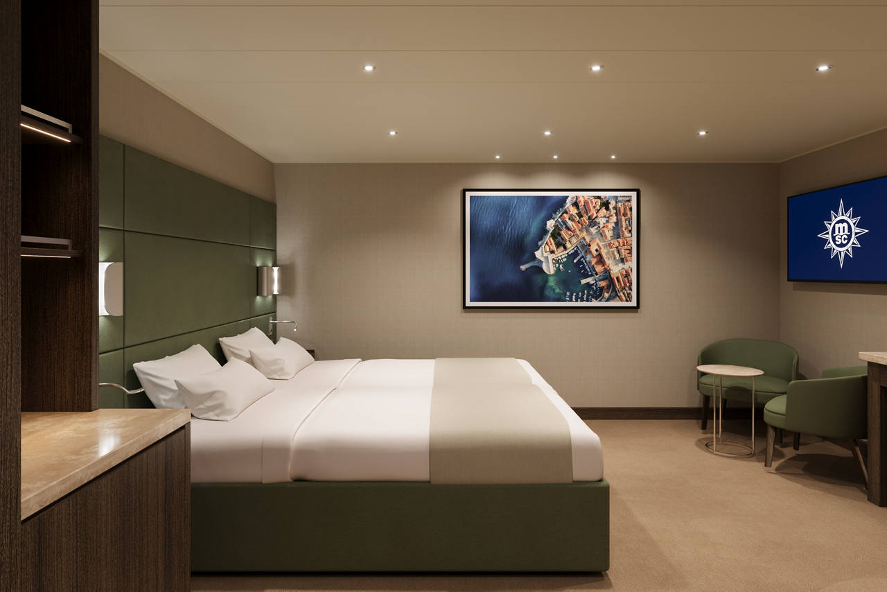 Modern room with two beds and a cozy sitting area | MSC Cruises