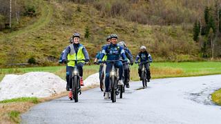 Two people cycling along a coastal path with a view of the sea | MSC Cruises