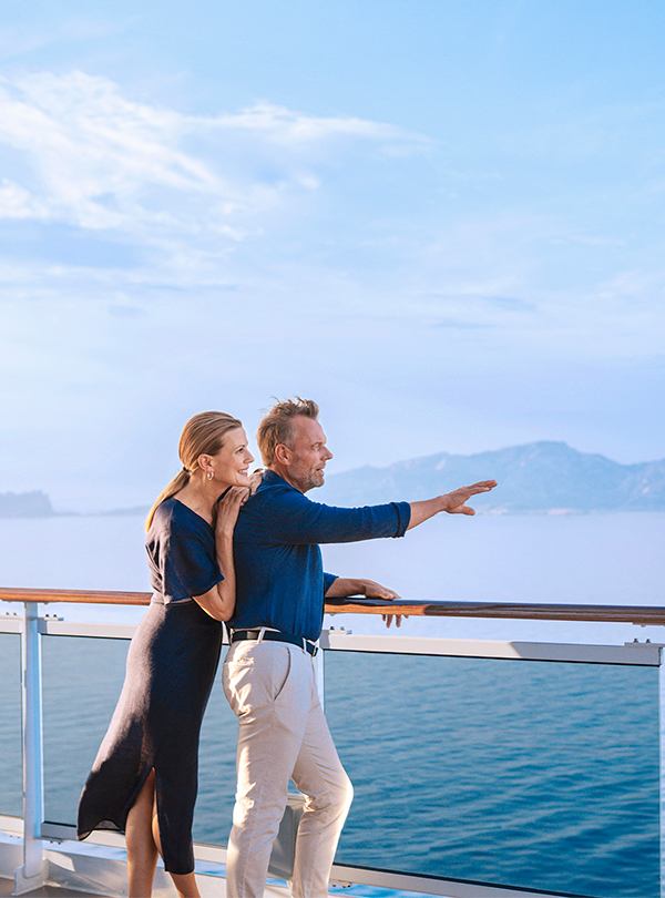 Couple embracing on a ship deck overlooking the sea | MSC Cruises