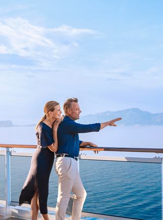 Couple embracing on a ship deck overlooking the sea | MSC Cruises
