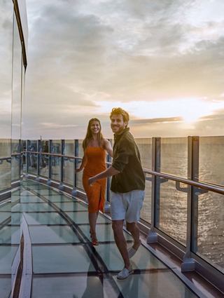 Two people enjoy a sunset together on the Infinity Bridge, MSC Seashore   | MSC Cruises