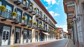 Urban scene with modern buildings and outdoor cafés along the street | MSC Cruises