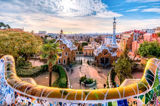 A vibrant view of Park Guell showcasing its iconic mosaic architecture, inviting exploration in sunny Barcelona | MSC Cruises
