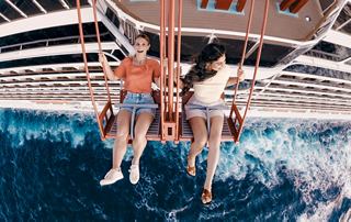 Two young people enjoy the sea from the deck of a cruise ship | MSC Cruises