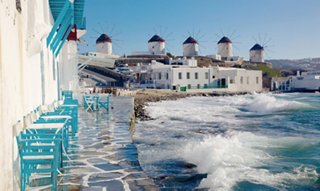 Scenic beach view with clear water and anchored boats | MSC Cruises