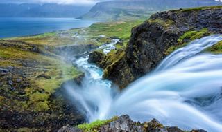 Fast flowing stream over rocks and green vegetation | MSC Cruises