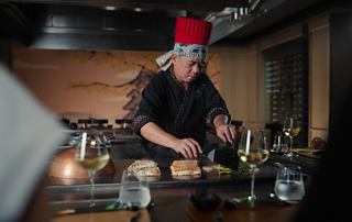 Chef preparing a dish in a restaurant setting | MSC Cruises