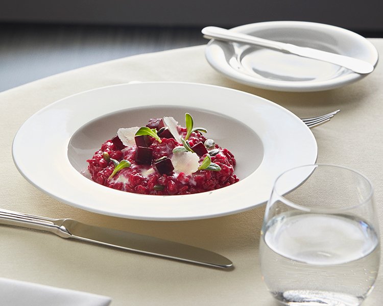 Elegant dinner with gourmet dish and red wine on the table | MSC Cruises