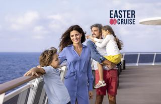A family enjoys a cruise on deck with the ocean in the background | MSC Cruises