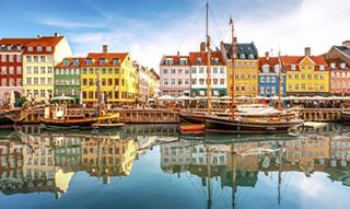Colorful buildings along a waterfront canal evoke a vibrant Northern European setting | MSC Cruises
