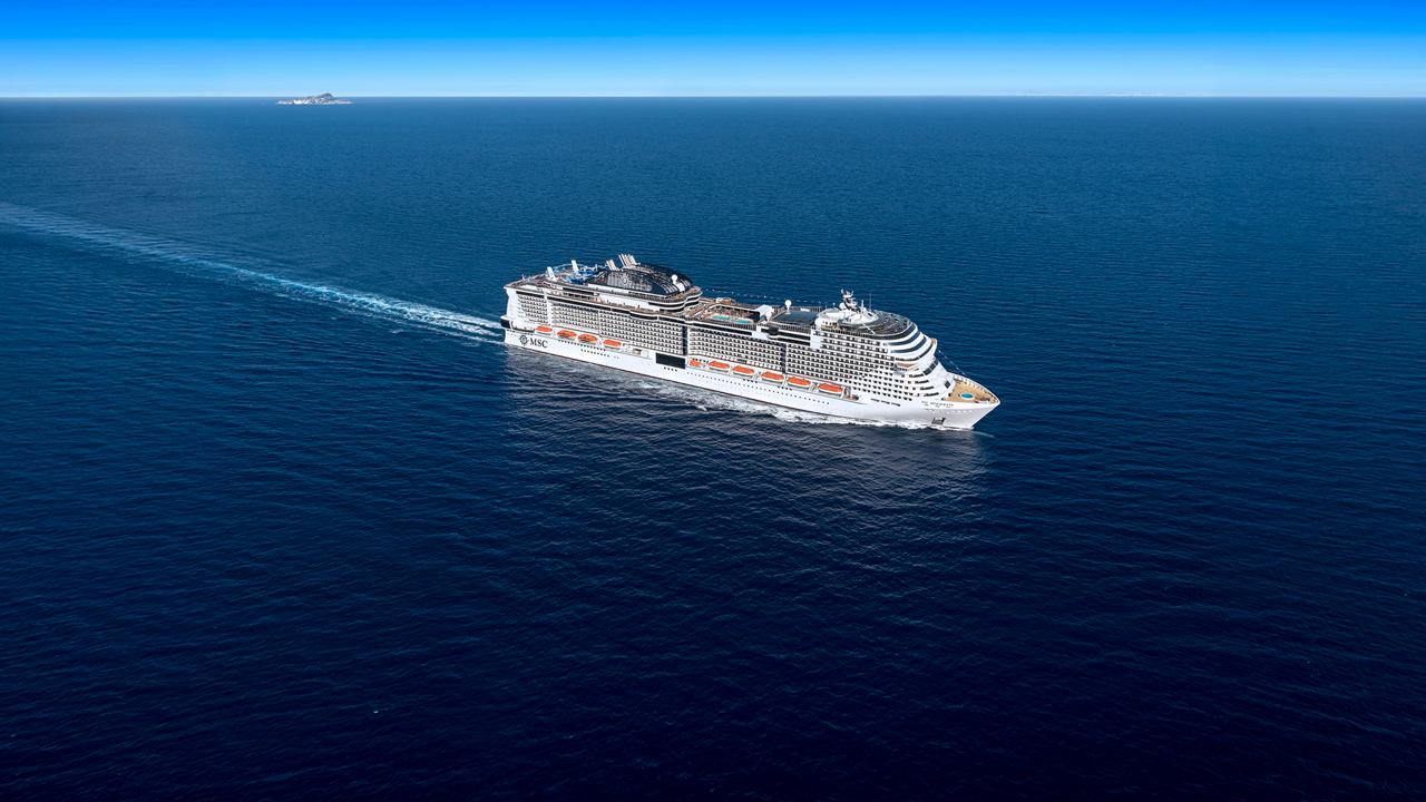 MSC Meraviglia, cruise ship sailing on open sea under clear blue sky | MSC Cruises