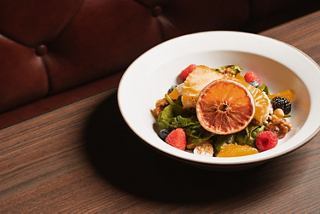 Chilean sea bass entrée served with vibrant vegetables in a stylish white bowl | MSC Cruises