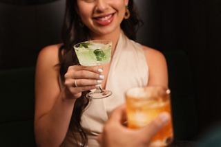 Two people share specialty cocktails in a welcoming and cozy setting | MSC Cruises