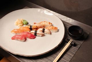 Variety of sushi on a white plate with soy sauce and chopsticks | MSC Cruises