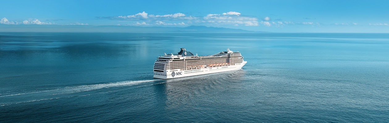 MSC Poesia cruise ship sails on calm waters beneath a clear blue sky | MSC Cruises
