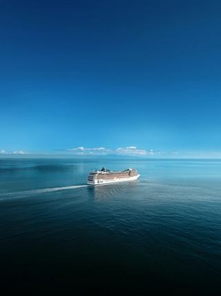 MSC Poesia cruise ship sails on calm waters beneath a clear blue sky | MSC Cruises