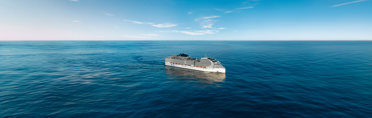 MSC World America sails across a vast blue sea beneath a clear and expansive sky | MSC Cruises