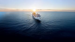A majestic cruise ship sailing on calm waters at sunset | MSC Cruises