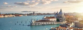 A stunning panoramic view of Venice's waterfront, showcasing the city's iconic architecture and vibrant waterways | MSC Cruises