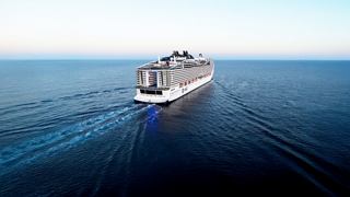 Aerial view of MSC World Europa sailing through calm blue waters | MSC Cruises
