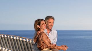 A couple enjoys a romantic moment by the sea, embracing the beauty of their surroundings | MSC Cruises