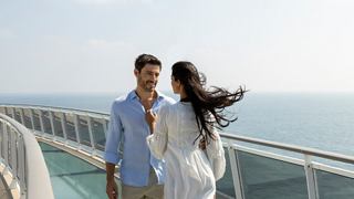 A couple enjoys a serene moment together by the sea, embracing the beauty of their surroundings | MSC Cruises
