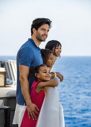 A couple enjoys time together on deck with the ocean in the background | MSC Cruises