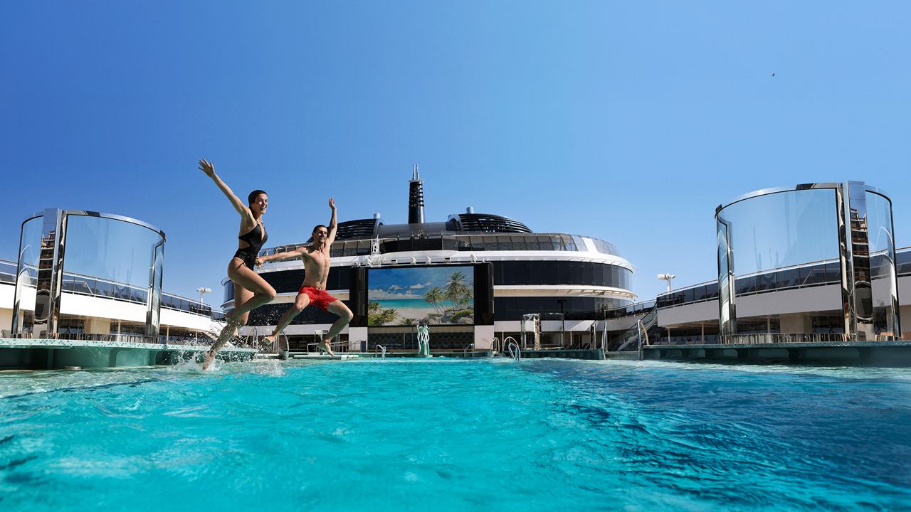 A panoramic view of a cruise ship with a vibrant pool area under a clear blue sky | MSC Cruises
