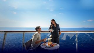 A couple enjoys a delightful breakfast on their balcony, overlooking the sea and sky | MSC Cruises