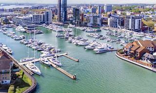 City marina with yachts and modern waterfront buildings | MSC Cruises