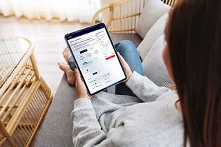 Woman at home using tablet to select cabin location with deck plan | MSC Cruises