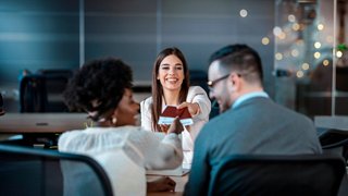 A couple engages in a warm conversation with a professional in a modern office setting | MSC Cruises