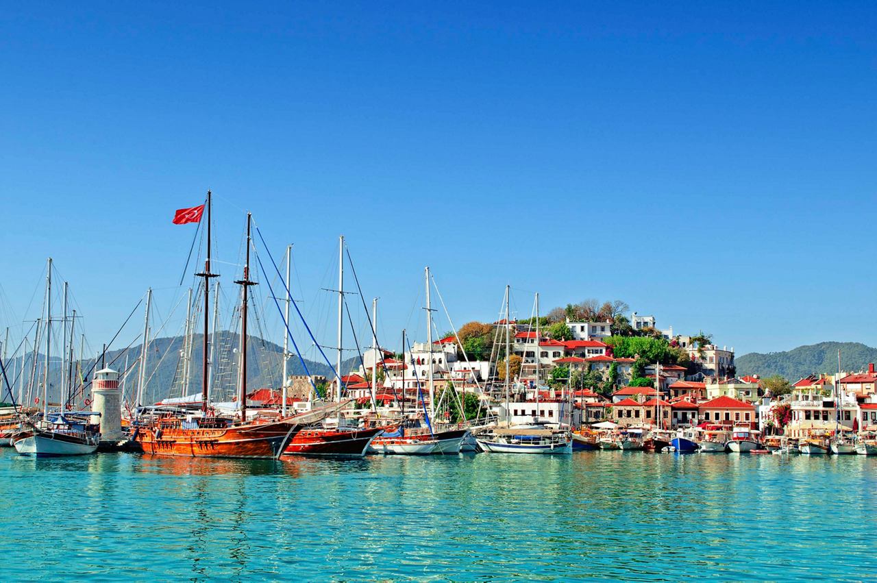 Marmaris harbor in Turkey with boats on turquoise water and a bright blue sky | MSC Cruises