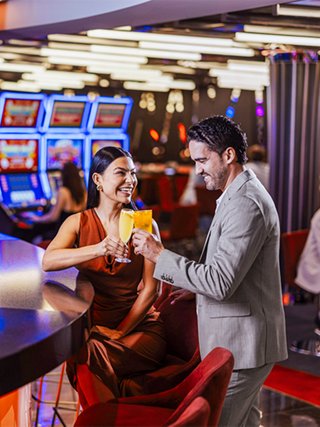 Couple exchanges chips in a vibrant casino setting | MSC Cruises