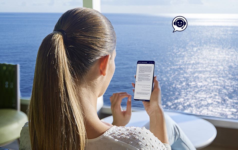 Woman using a mobile phone while enjoying the sea view from the terrace | MSC Cruises