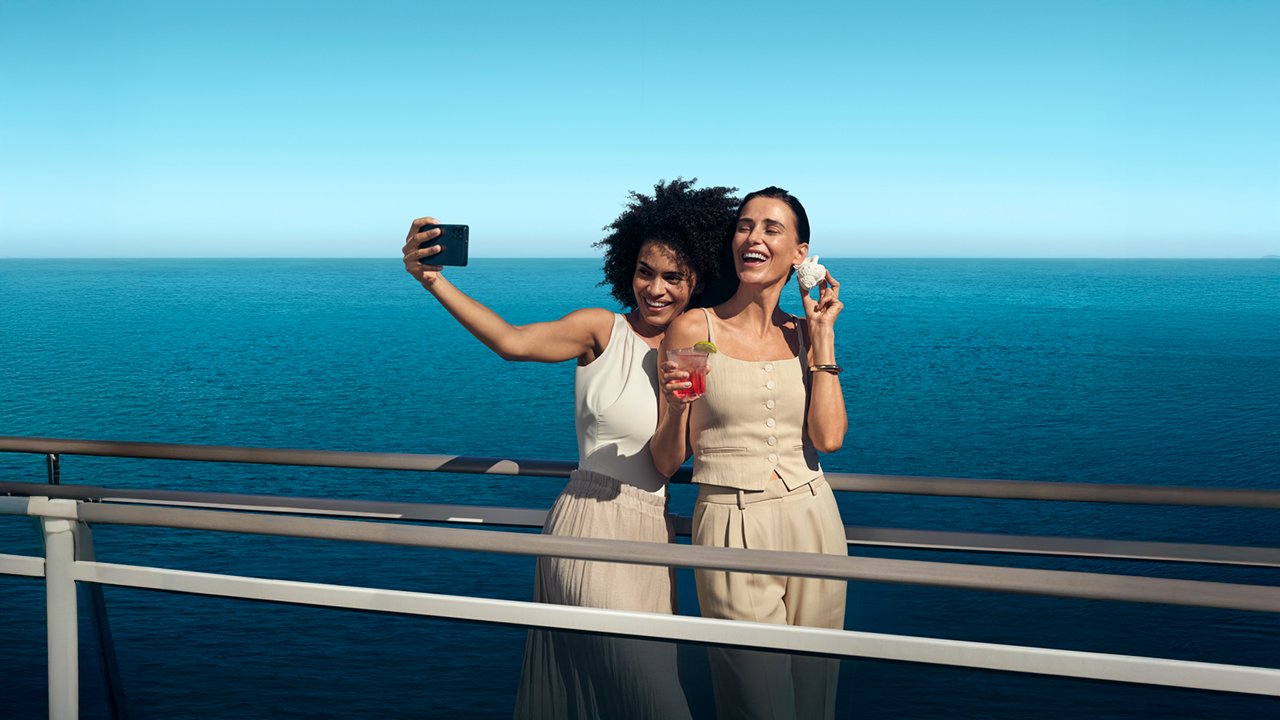 Two women take a selfie on a ship with a beautiful ocean backdrop | MSC Cruises