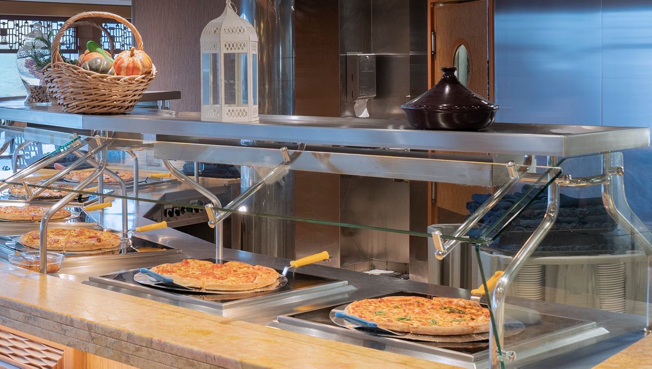 Variety of hot dishes in cruise ship restaurant buffet | MSC Cruises