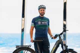 Smiling bike tour leader near MSC Euribia ship by the sea | MSC Cruises