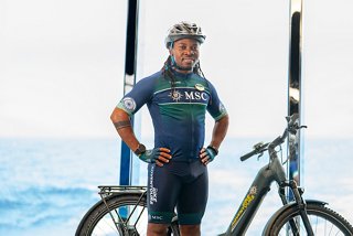 Happy MSC Euribia crew member with bike on board a cruise ship | MSC Cruises