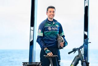 MSC Euribia crew smiling with sea and sky background during bike tour | MSC Cruises