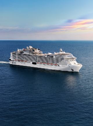 The MSC Bellissima gracefully sails through calm waters under a beautiful sky | MSC Cruises