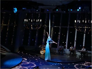 A talented performer takes the stage, surrounded by lights that create an inspiring atmosphere | MSC Cruises