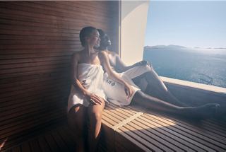 A couple relaxes in a spa with mountain views, enjoying peace and tranquility | MSC Cruises
