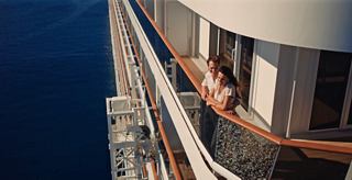 A cruise ship balcony overlooking the sea, offering a cozy space for relaxation | MSC Cruises