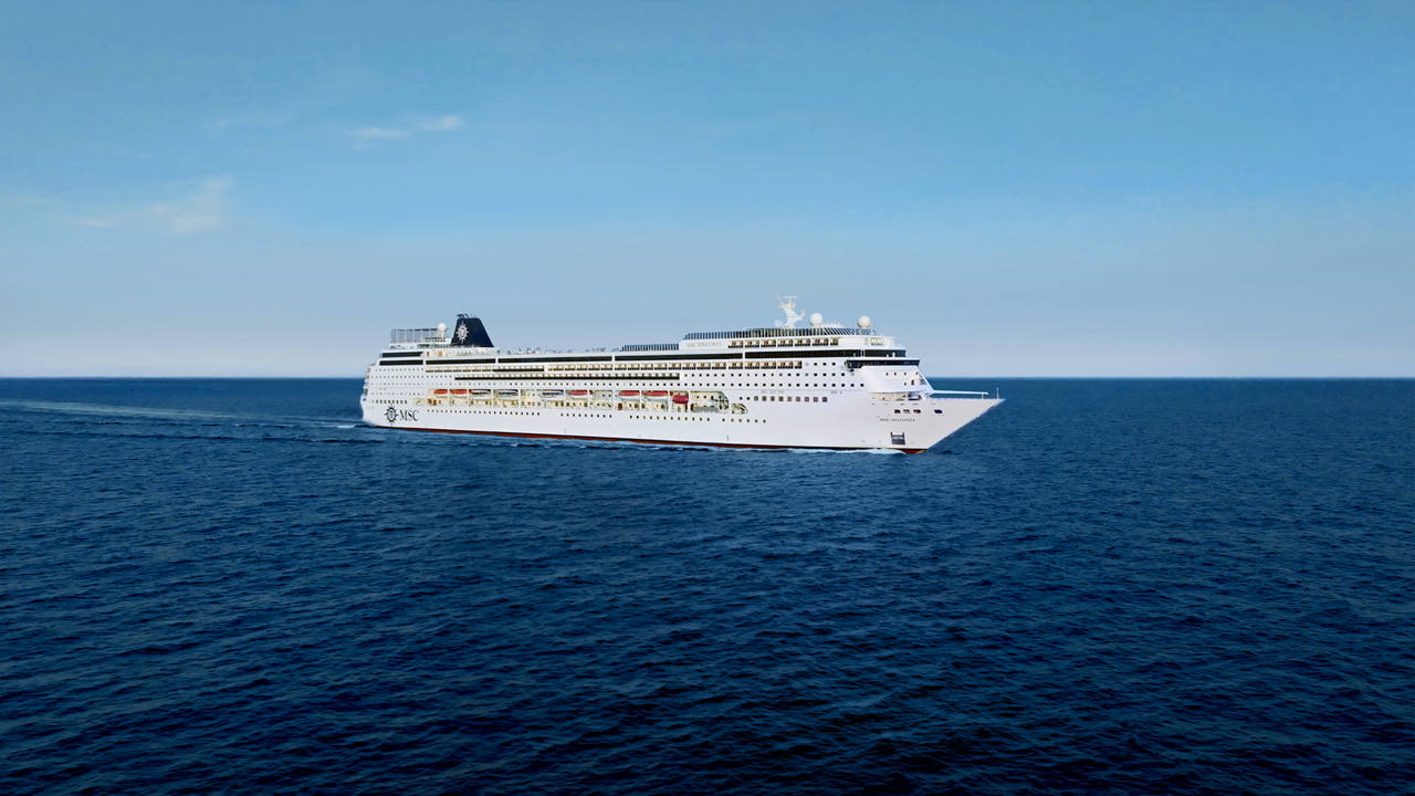The MSC Sinfonia gracefully sails through calm blue waters under a clear sky | MSC Cruises