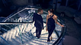 Two women enjoy the crystal staircase illuminated by soft lighting | MSC Cruises