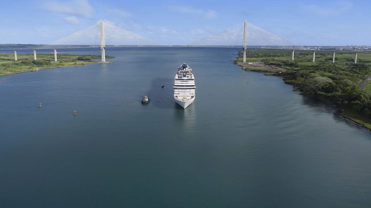 Panama Canal with a ship sailing on calm waters on a clear day | MSC Cruises