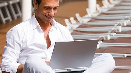 Guests relaxing on outdoor lounge with sea view | MSC Cruises