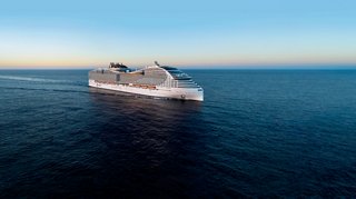 The MSC World Europa ship sails gracefully across the calm sea under a clear sky | MSC Cruises